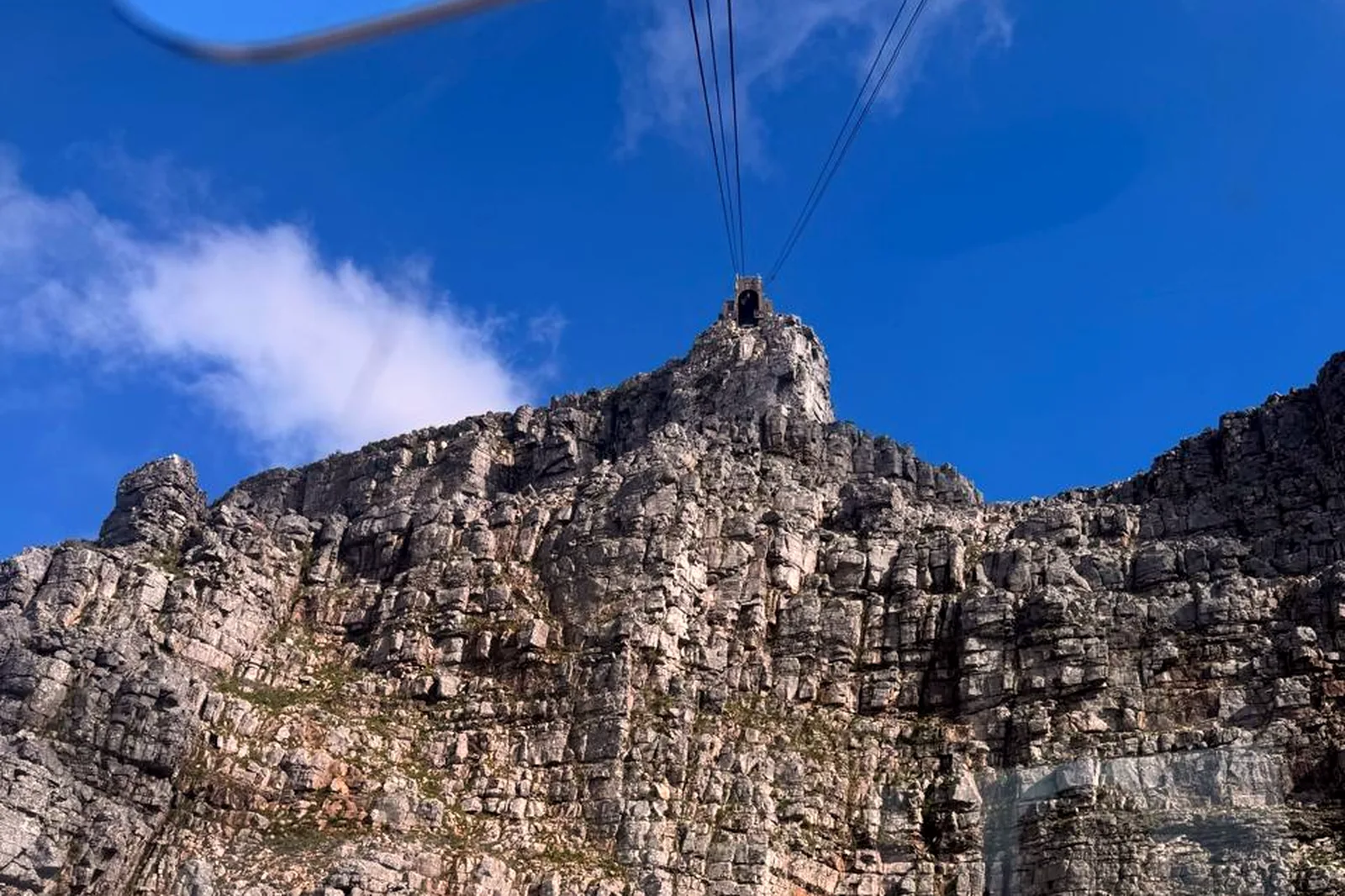 Cable car cresting the cliffs of Table Mountain in Cape Town